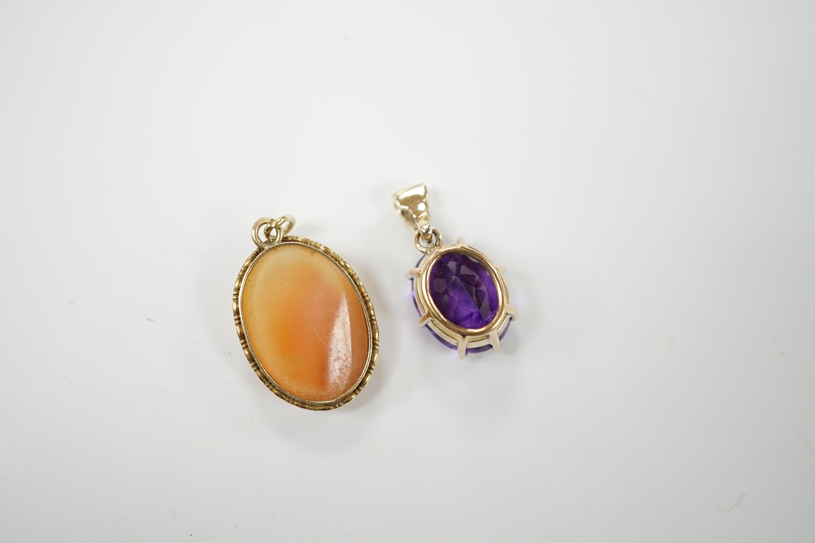 A yellow metal amethyst and diamond set pendant, 2cm, and a cameo pendant, stamped 585